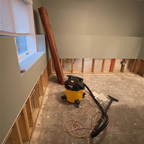 Water-damaged lower level undergoing flood cuts and structural drying after week-long supply line failure