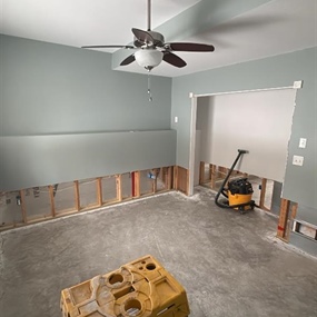 Basement wall systems opened for structural drying after extensive water damage from a hidden plumbing leak