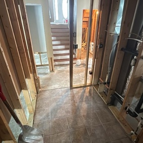 Exposed framing and wall cavities prepared for moisture removal during water mitigation services in Medford