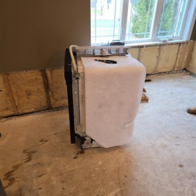 Dishwasher removed during water damage restoration after a broken refrigerator supply line flooded a Medford home
